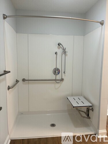 A white bathroom with a walk in shower.