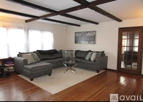 A living room with a grey couch and a coffee table.