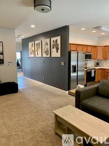 A living room with a grey couch and a wooden coffee table.