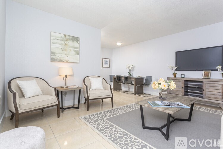 A living room with a sofa, armchairs, and a coffee table.