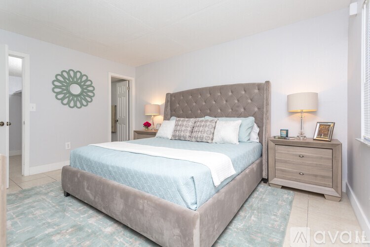 A bedroom with a large bed and a dresser.