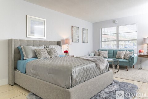 A bedroom with a large bed and a couch.