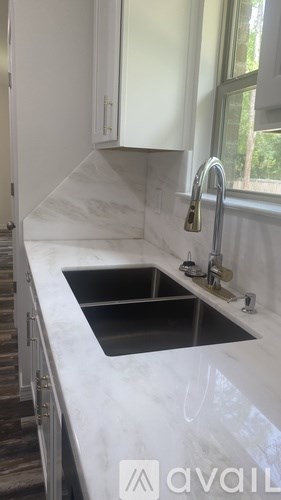 A kitchen with a sink and a window.