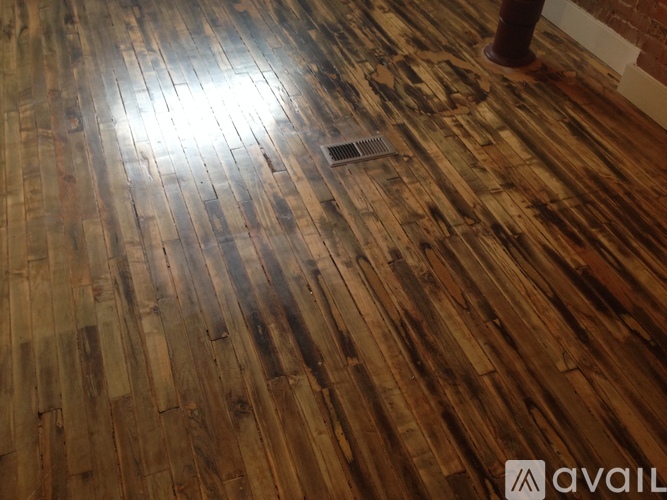 A wooden floor with a light shining on it.