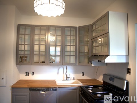 A kitchen with a wooden counter top and a stove.