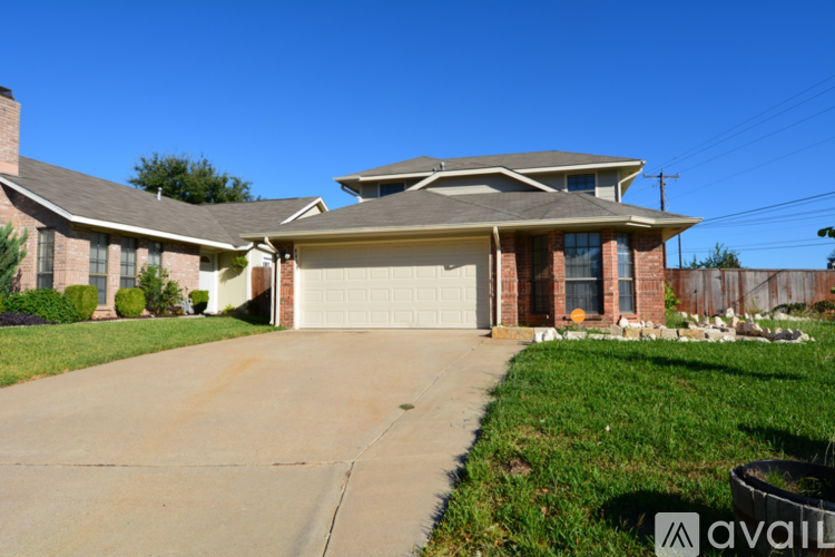 A house with a garage and a driveway in front.