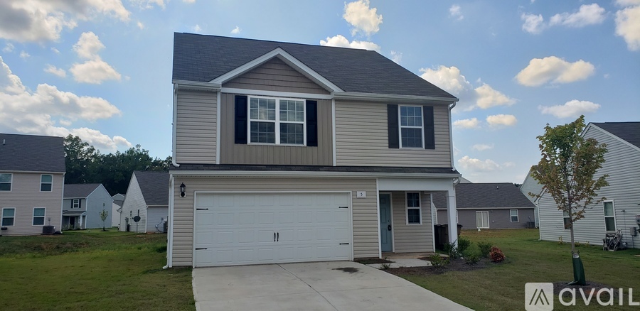 A house with a garage is available for sale.