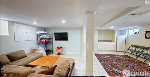 A living room with a brown couch and a television.