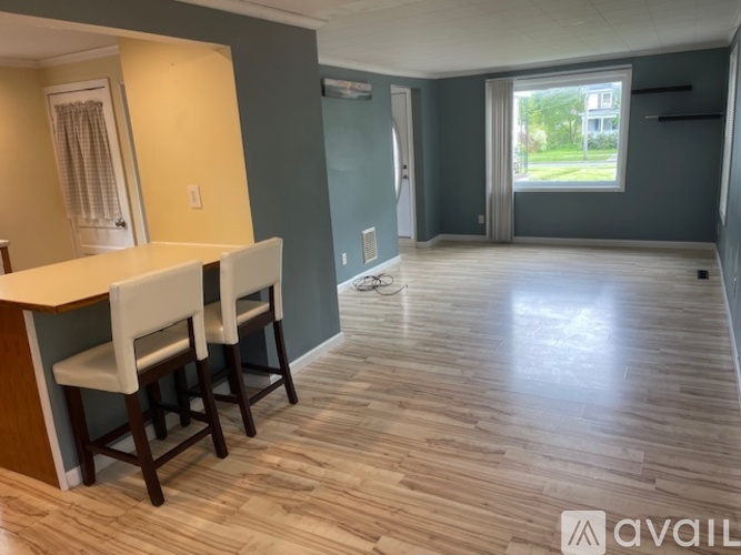 A room with a bar and two chairs.