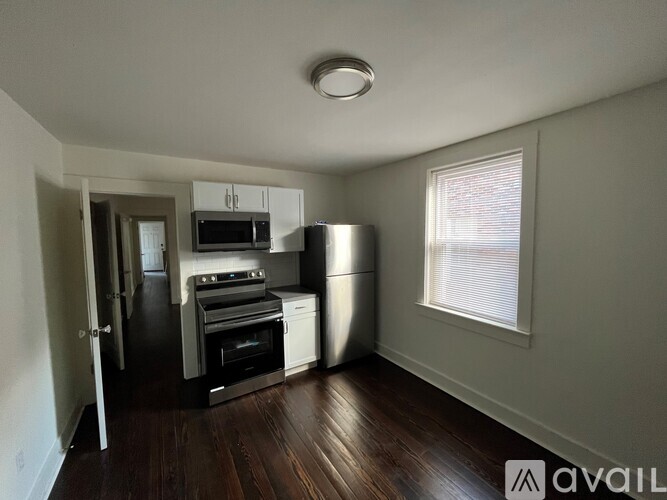 A kitchen with wooden cabinets and a refrigerator.