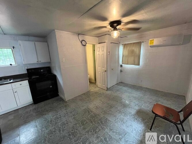 A room with a ceiling fan and a chair is available for rent.
