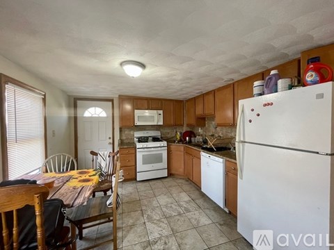 A kitchen with a table and chairs in it.