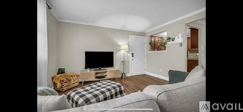 A living room with a television and a couch.