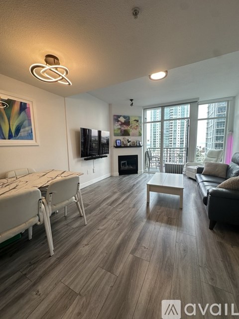 A living room with a white dining table and a white sofa.