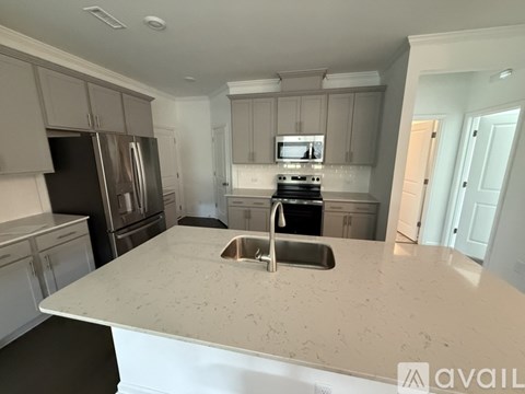 A kitchen with a marble countertop and stainless steel appliances.