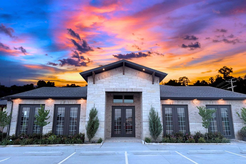 A building with a parking lot in front of it.