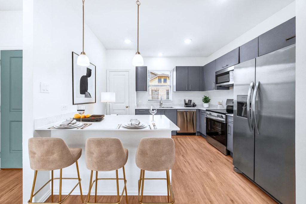 A modern kitchen with a dining table and chairs.