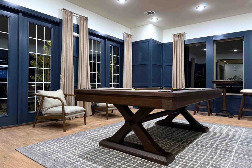 A dining room with a wooden table and chairs.