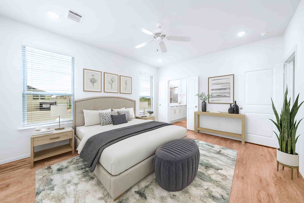 A bedroom with a large bed and a ceiling fan.