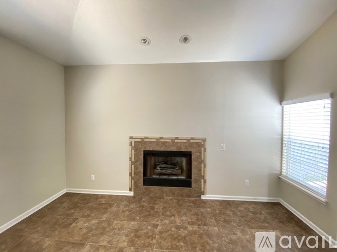 A room with a fireplace and a window.