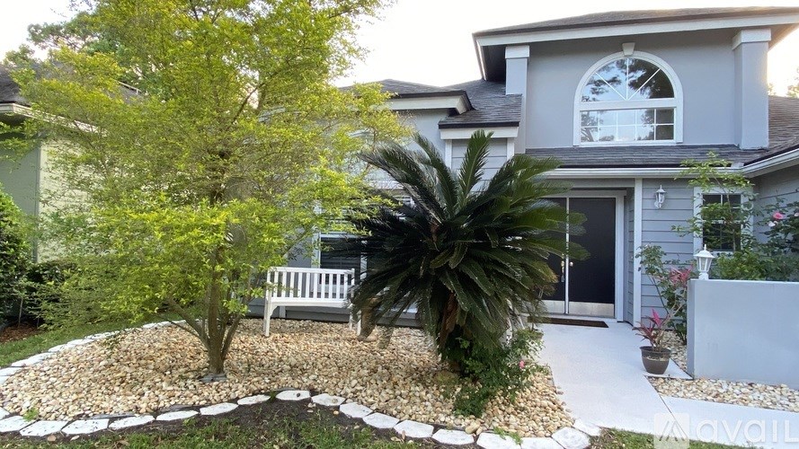 A house with a garden in front of it.