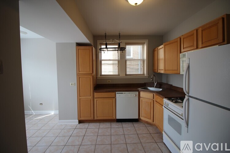 A kitchen with wooden cabinets and white appliances.