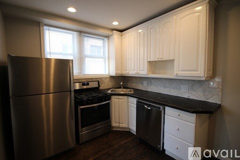 A kitchen with wooden cabinets and white appliances.