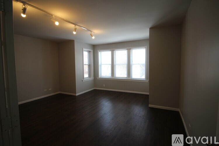 A room with a fireplace and wooden floors.