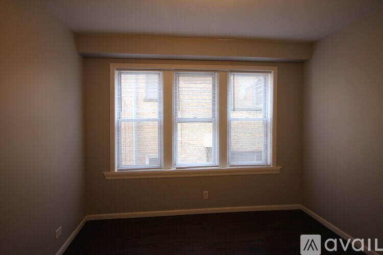 A room with a ceiling fan and a window.