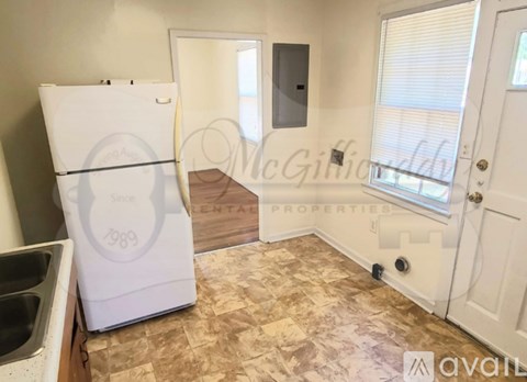 A kitchen with a white fridge and a counter top.