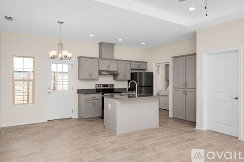 A spacious kitchen with a large island in the middle.