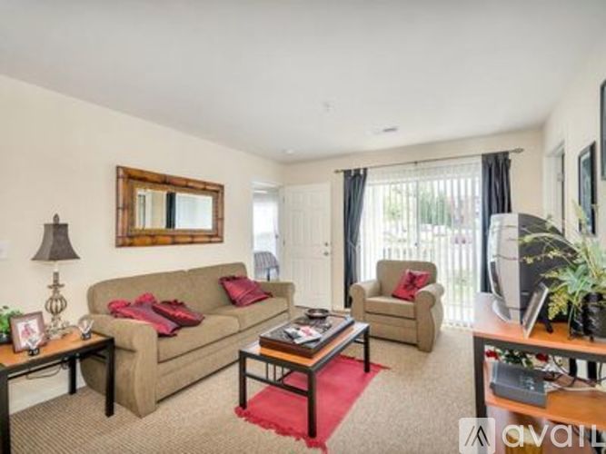 A living room with a couch, chair, and coffee table.