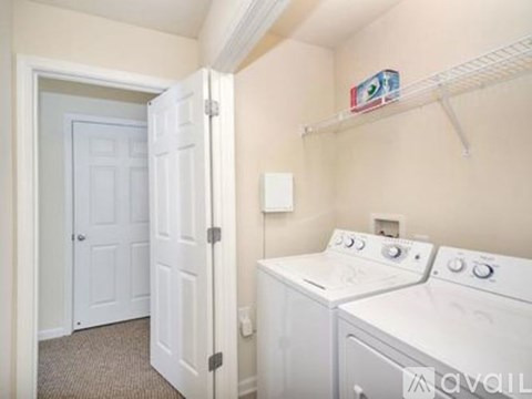 A small laundry room with a washer and dryer.