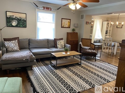 A living room with a grey couch and a coffee table.