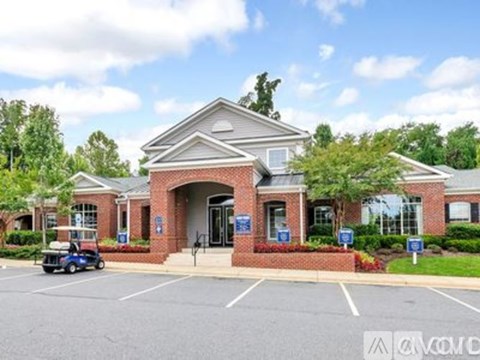 A building with a parking lot in front of it.