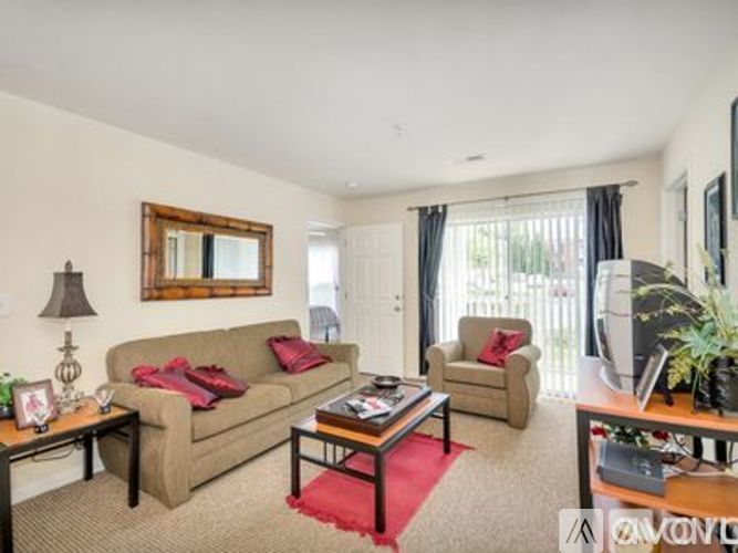 A living room with a couch, chair, and coffee table.