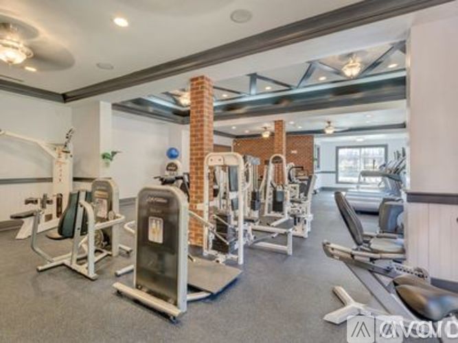 A well-equipped gym with various exercise machines and weights.