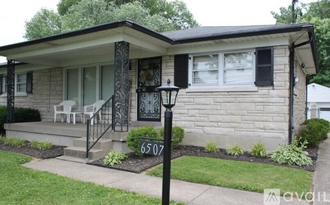 A house with the number 6507 on the front lawn.