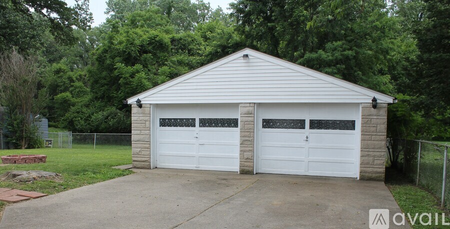 A two-car garage with a white door and a grey roof.