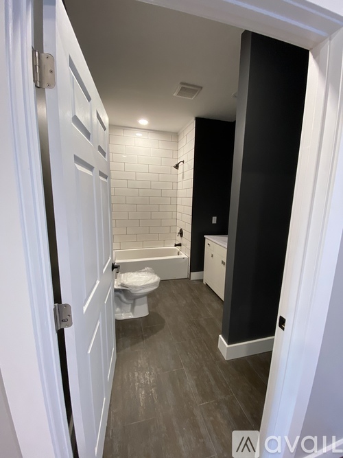 A bathroom with a toilet, sink, and bathtub.