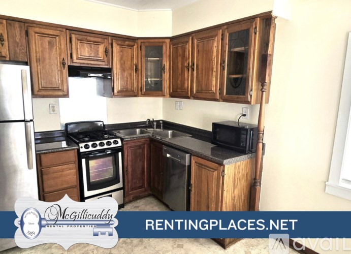 A room with a fan on the ceiling and a carpet on the floor.