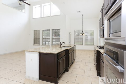 A kitchen with brown cabinets and a white countertop.