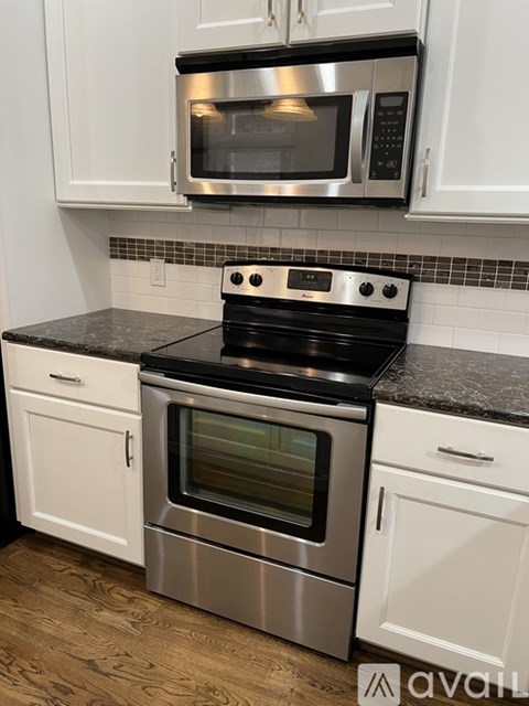 A kitchen with a stove top oven and microwave above it.