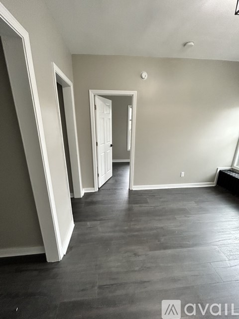 A room with a grey floor and white walls.