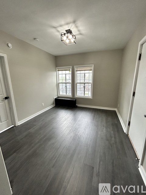 A room with a window and a light on the ceiling.