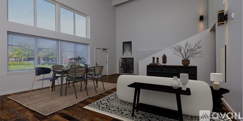 A modern living room with a dining table and chairs.