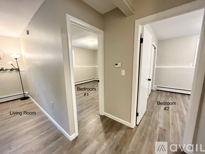 A living room with two bedrooms.
