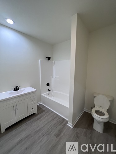 A bathroom with a toilet, sink, and bathtub.