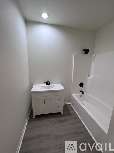 A white bathroom with a sink, toilet, and bathtub.