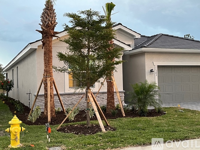 A house with a yellow fire hydrant in front of it.